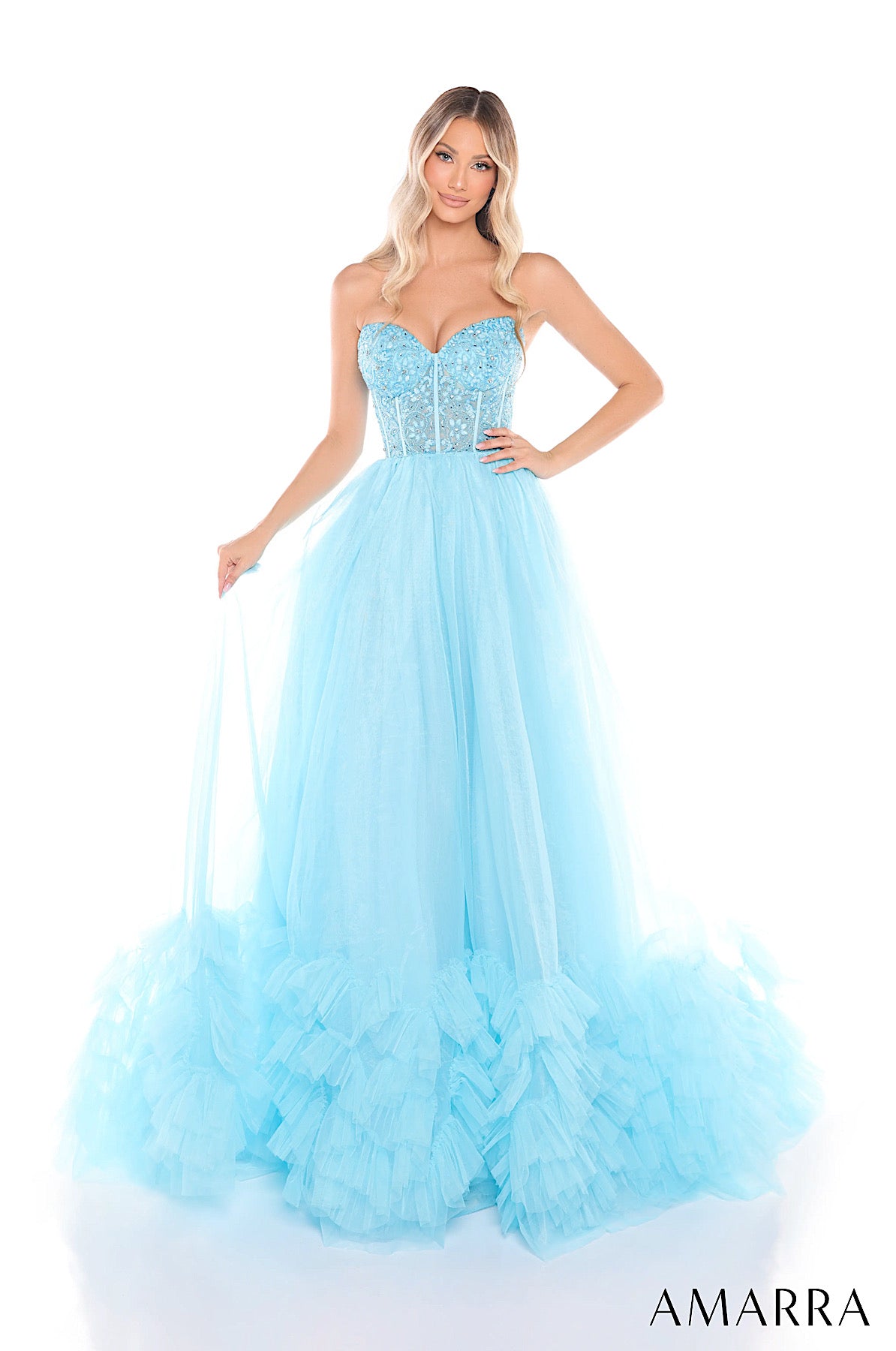 Woman wearing a light blue dress with a beaded bodice on a white background, brand 'AMARRA' visible.