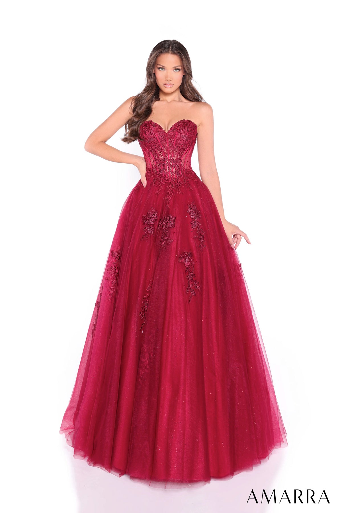 Red evening gown with intricate detailing on a white background, featuring the brand 'AMARRA'.