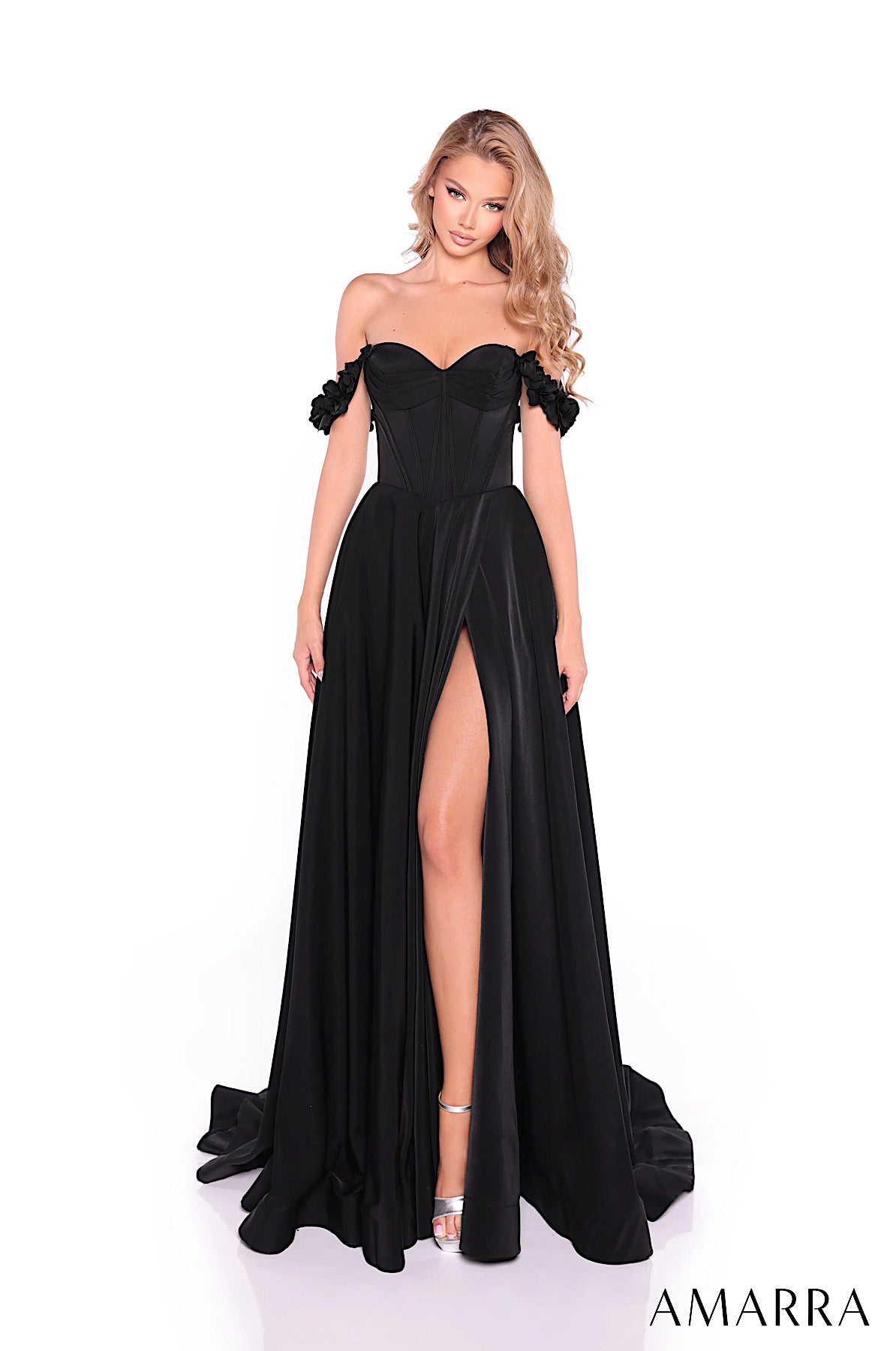 Black evening gown with ruffled straps and a high slit on a white background, brand 'AMARRA' visible.