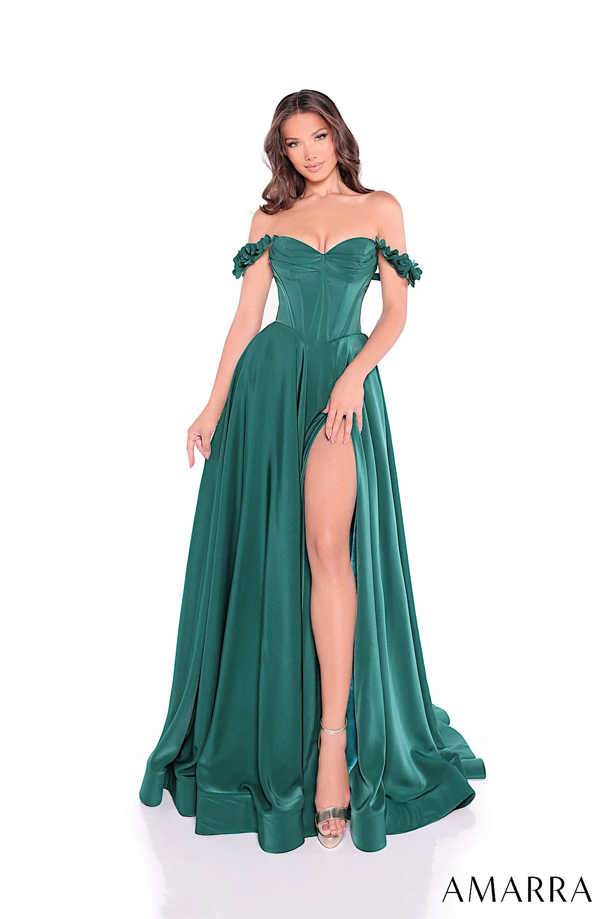 Green evening gown with off-shoulder design and high slit on a white background, featuring the brand 'AMARRA'.