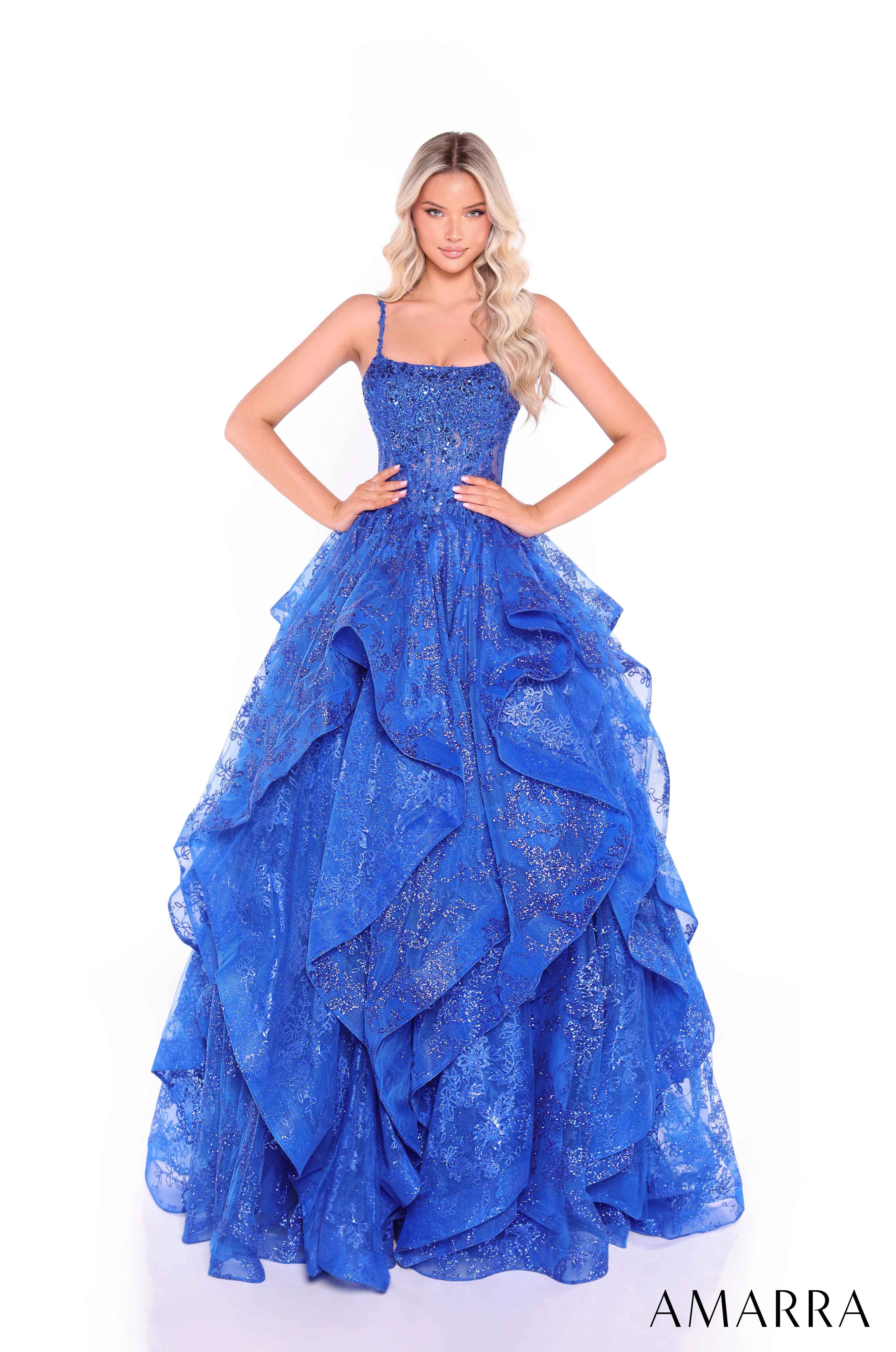 Blue evening gown with ruffled layers on a white background, brand 'AMARRA' visible.
