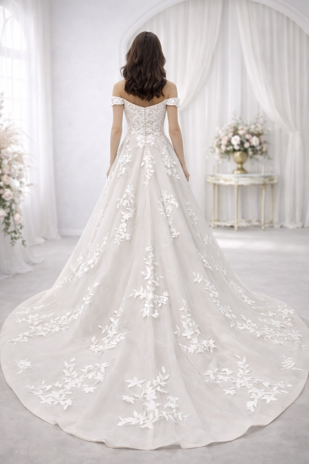White wedding dress with floral embroidery in a softly lit room.
