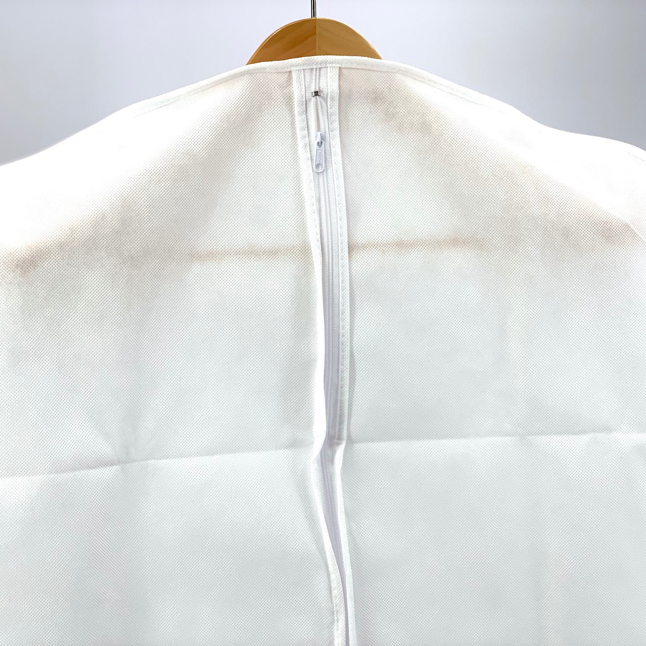 White jacket with a zipper on a gray background