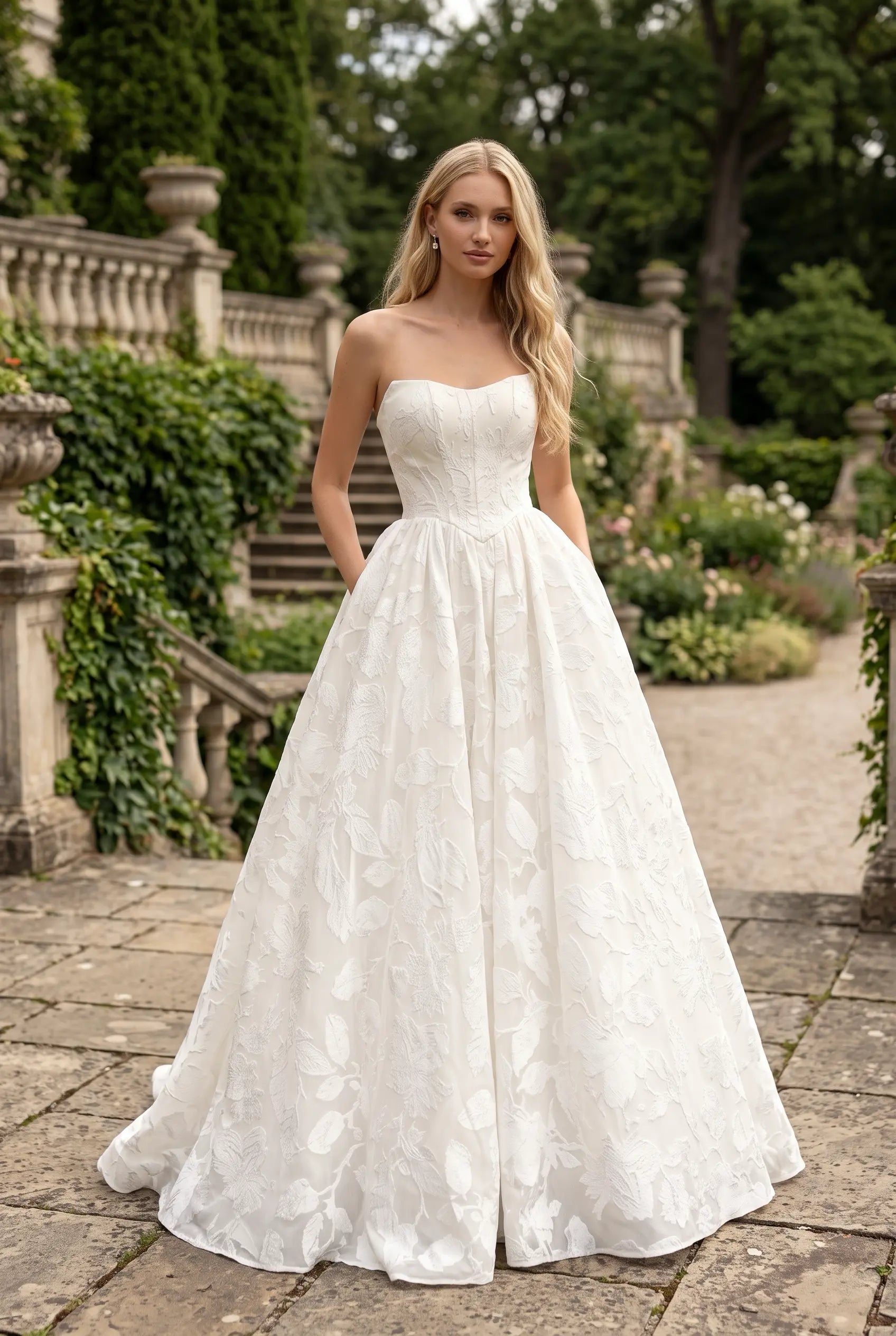 Featuring a sculpted sweetheart corset bodice and a voluminous full skirt with a dramatic train. Shop the look today.